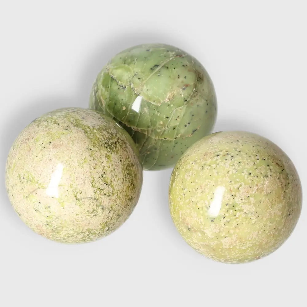 Three polished Serpentine spheres in vibrant green hues representing balance and wholeness, ideal for meditation or décor.