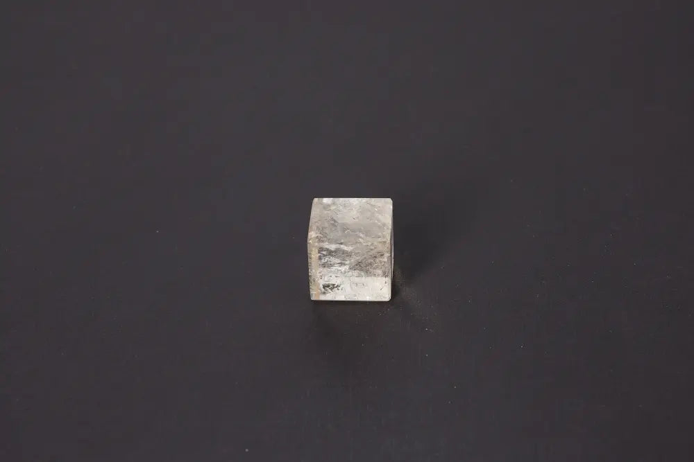 Smoky Quartz Cube 3 cm on black background, showcasing its grounding energy and translucent gray-brown tones for stability and protection.