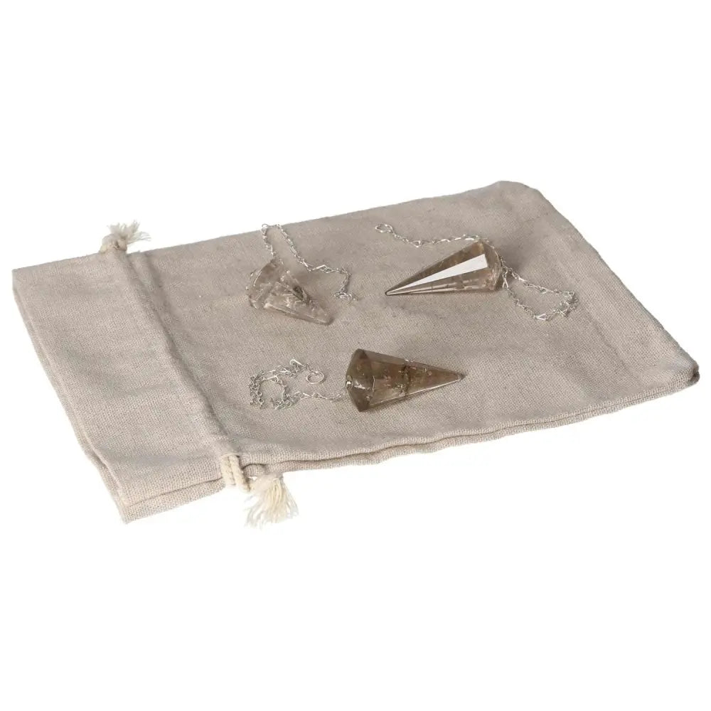 Smoky Quartz pendulum set on a beige pouch, ideal for decision-making and conflict resolution support.