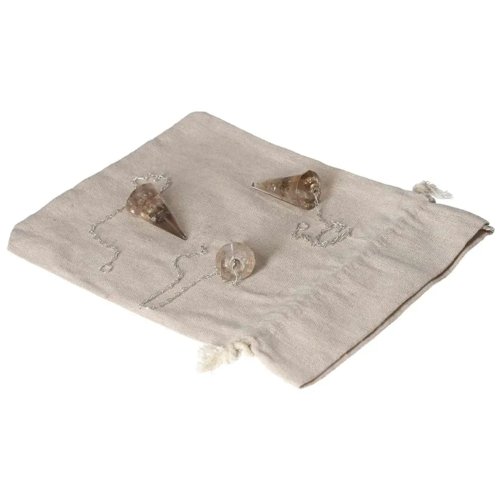 Set of smoky quartz pendulums on beige cloth, ideal for decision-making and financial management, perfect for business professionals.