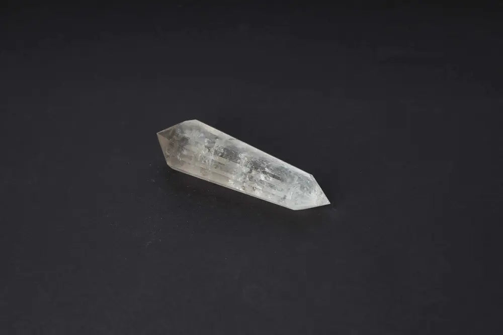 Polished Smoky Quartz Point for grounding, protection, and energy transformation on a black background.