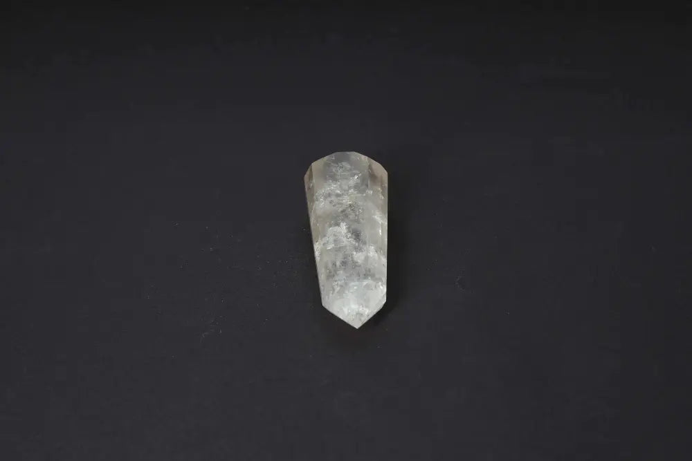 Smoky Quartz Point crystal on dark background, showcasing its translucent warm tones and polished surface for grounding and protection.