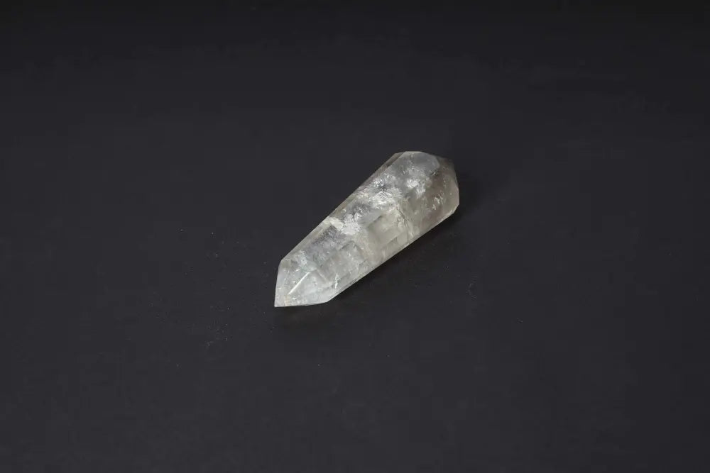 Polished Smoky Quartz point crystal on black background, showcasing grounding and protective energy properties.