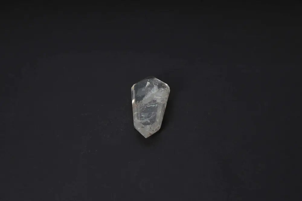 Smoky Quartz Point crystal on dark background, offering grounding clarity and protective energy with translucent, warm tones.