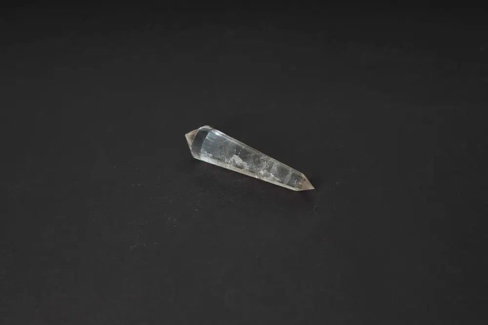 Polished Smoky Quartz Point on dark background, offering grounding and protective energy with warm, translucent hues for emotional balance.