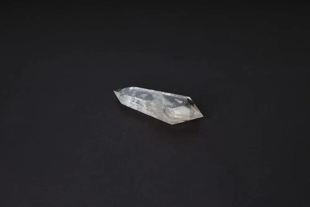 Polished Smoky Quartz Point for grounding and protection, featuring warm translucent tones to deep brown on a black background.