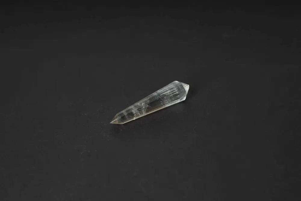 Smoky Quartz Point on black background, showcasing translucent tones for grounding, protection, and emotional balance.