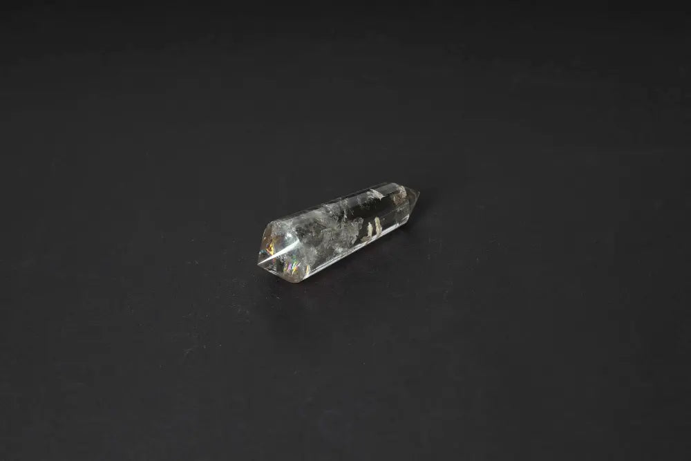Smoky Quartz Point crystal on dark background, showcasing translucent tones and polished surface for grounding and protective energy.