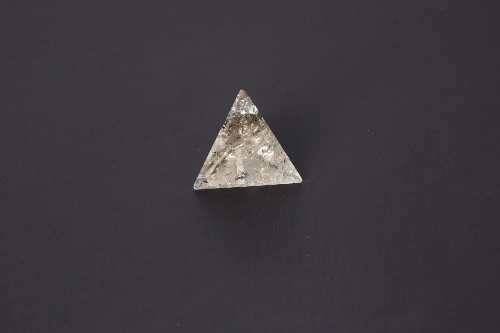 Smoky Quartz Pyramid 5 cm with grounding energy, rich translucent tones from soft gray to deep brown, on a dark background.