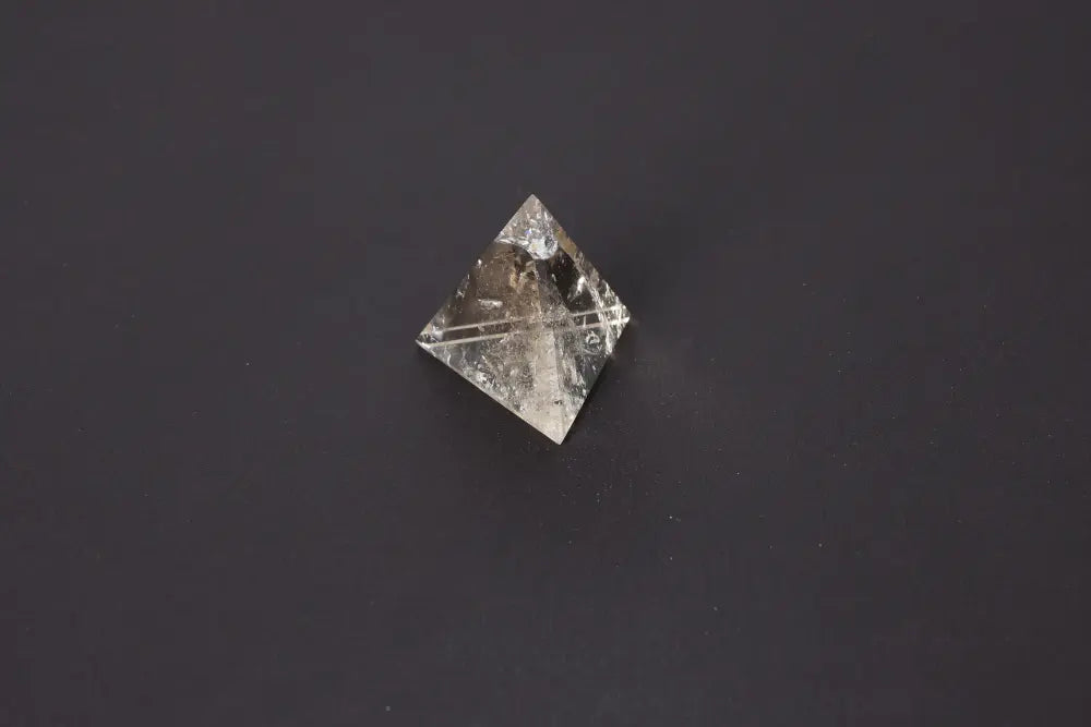 Smoky Quartz Pyramid 5 cm for grounding energy, showcasing translucent earthy tones on a dark background.