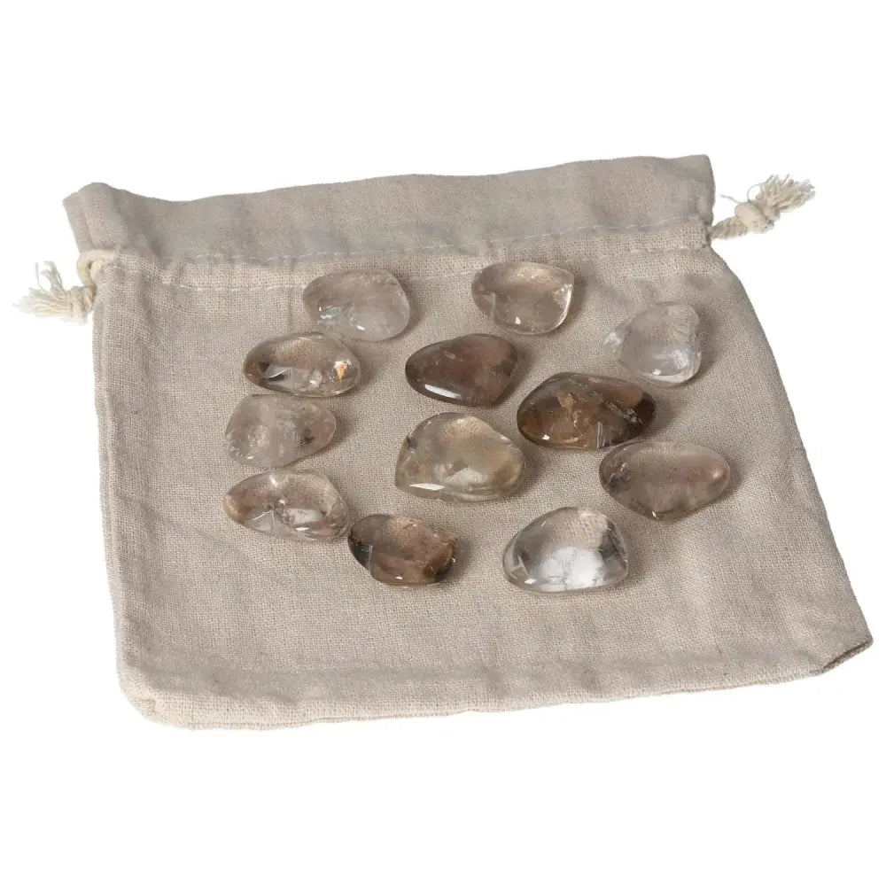 A collection of smoky quartz small heart-shaped stones on a cloth pouch, ideal for grounding and decision-making support.