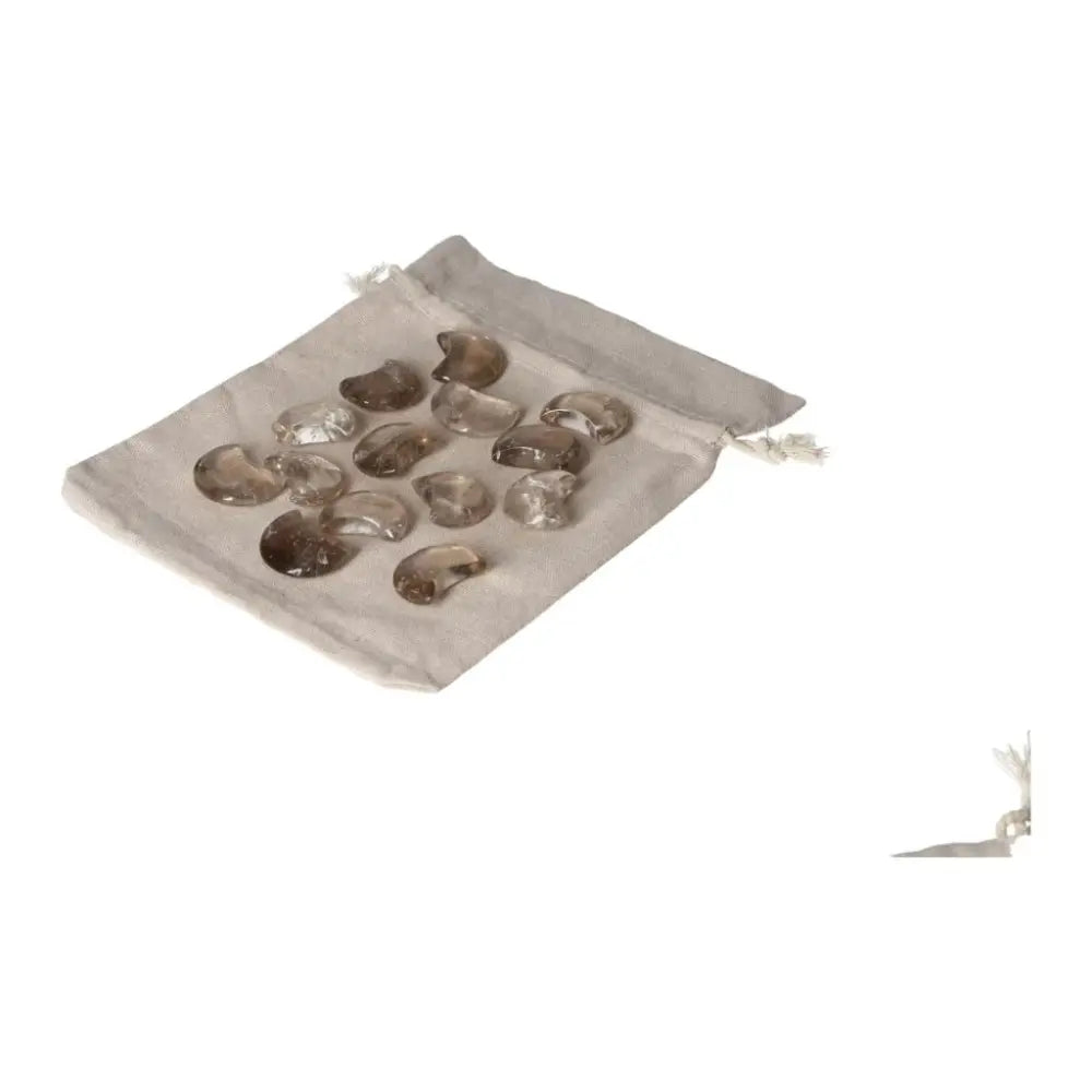 Assorted Smoky Quartz small moon-shaped stones on a beige pouch, perfect for decision-making and grounding energy.