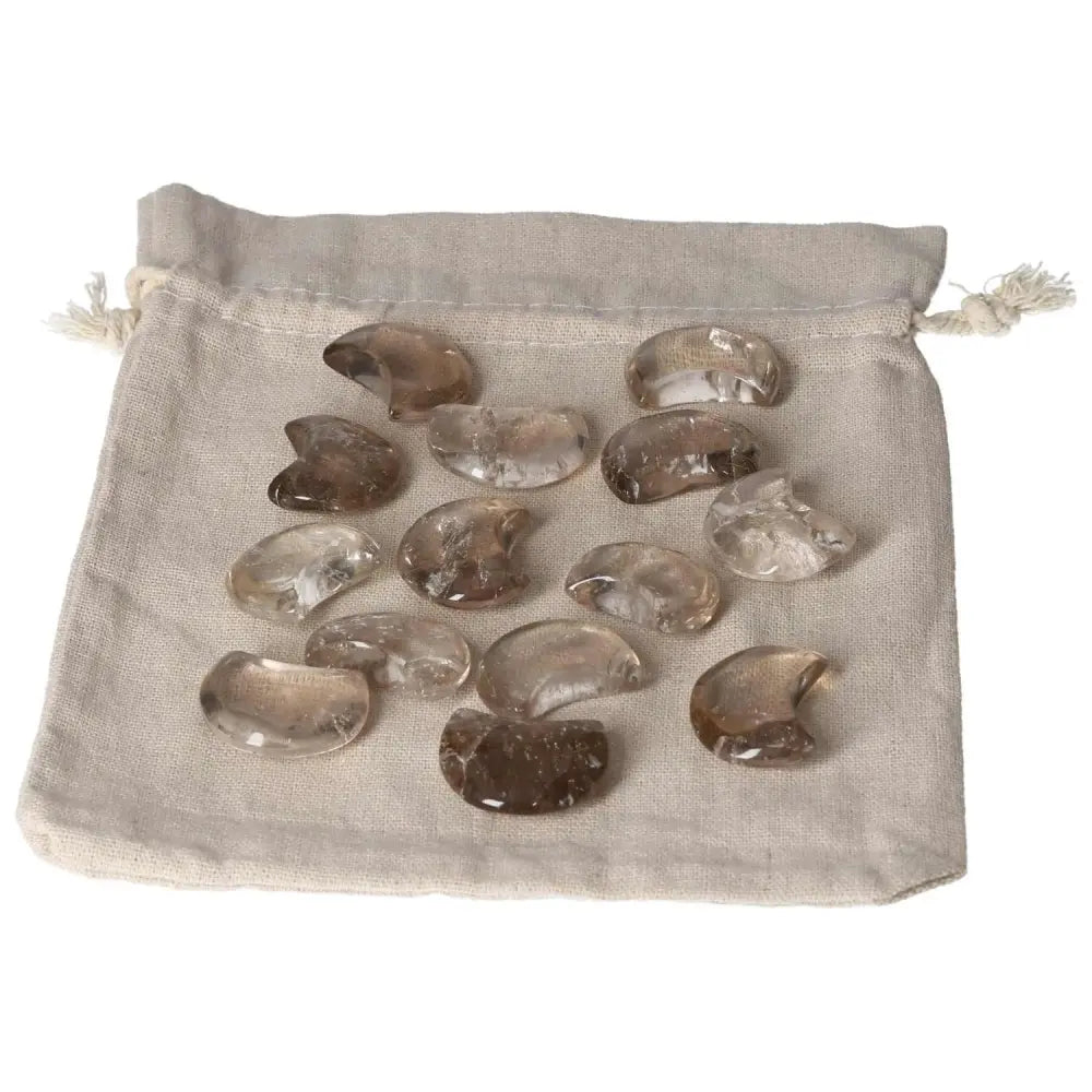 Smoky Quartz Small Moon stones displayed on a beige cloth pouch, enhancing decision-making and practical thinking.