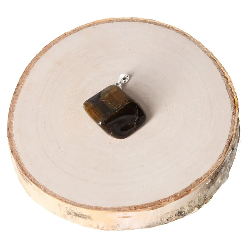 Tigers Eye Multicolor Tumbled Pendant with rich earthy tones on a natural wood base, showcasing unique patterns and high-quality craftsmanship.
