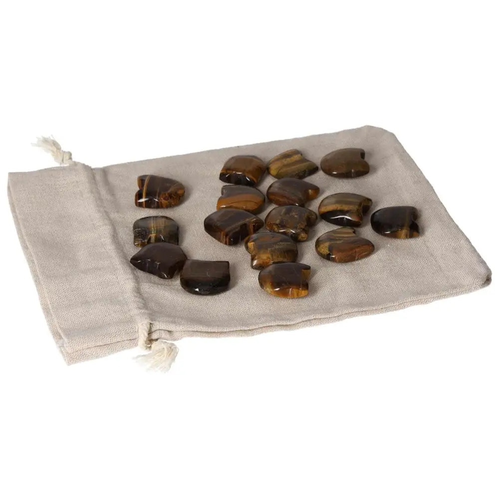 Tigers Eye small cat stones on a beige cloth, supporting joy, clarity, and stability for wealth management and mental focus.