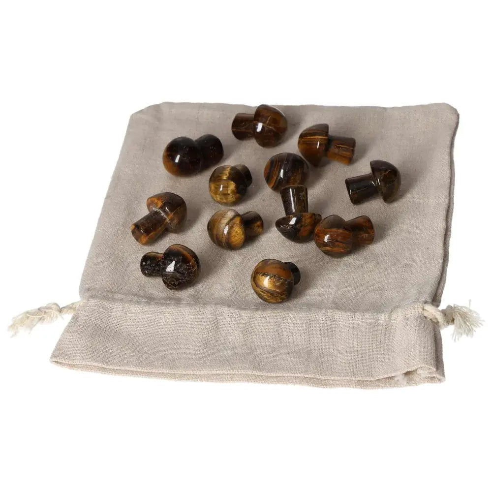 Tigers Eye small mushroom set on linen pouch, known for enhancing mental clarity and stability, perfect for focus and wealth management.