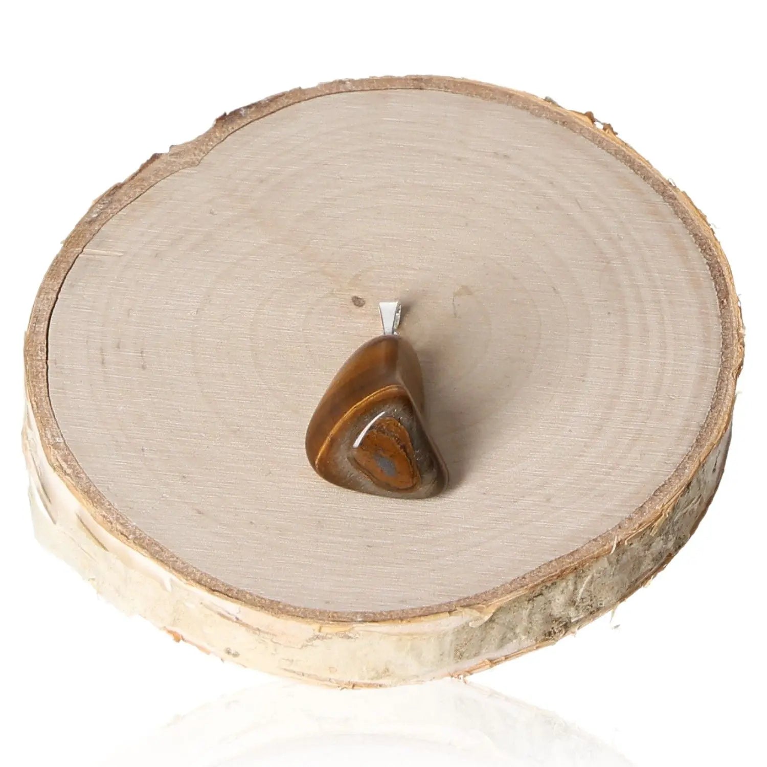 Tigers Eye Tumbled Pendant on natural wood slice, showcasing golden and brown striped gemstone with elegant and grounding properties.