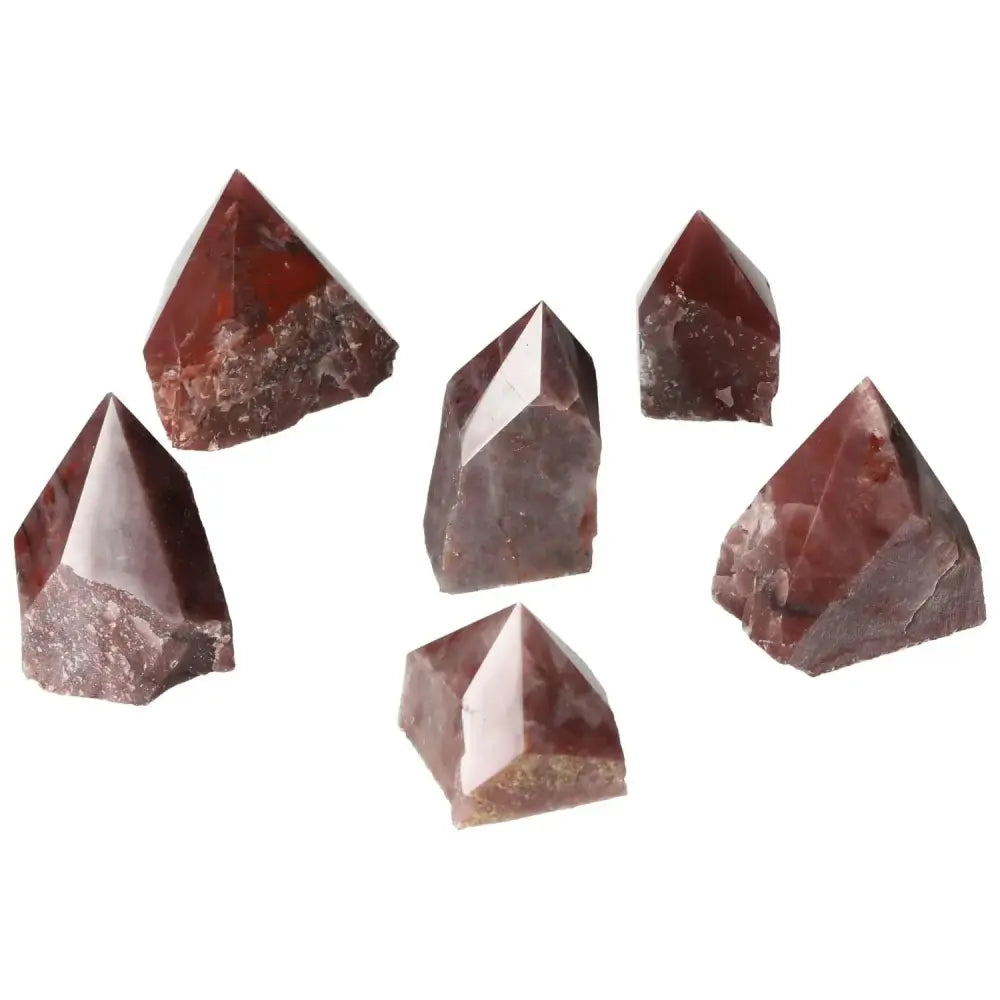 Collection of Top Polished Point Guava Quartz S crystals in various shapes, featuring a stunning guava hue and polished finish.