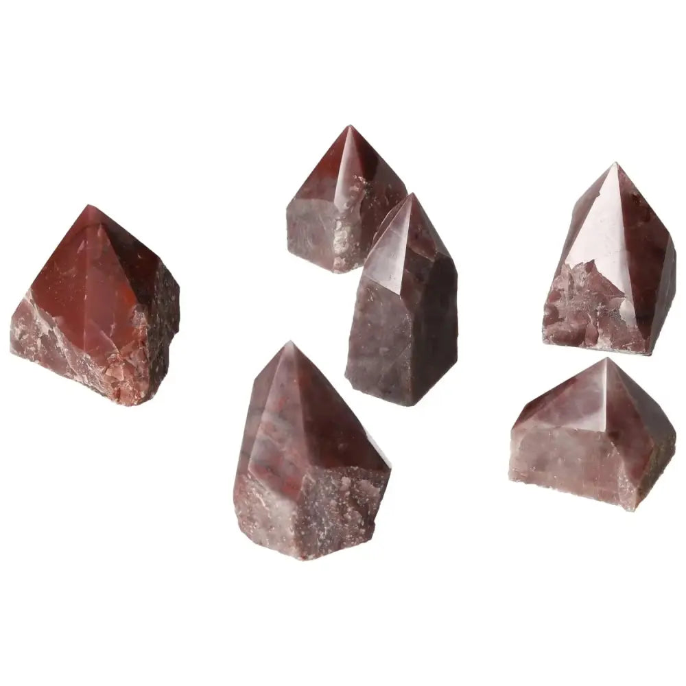 Five top polished point guava quartz crystals with a delicate hue, renowned for aesthetic and spiritual benefits.