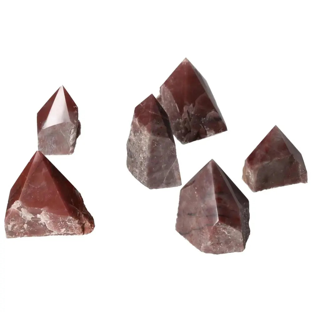 Assorted polished guava quartz crystals from Sylvia Crystals, featuring a delicate guava hue and spiritual chakra properties.
