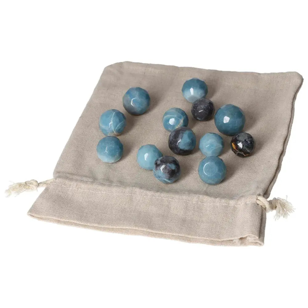 Trolleite small geometric spheres on a cloth bag, showcasing rich blue to violet hues for spiritual awareness and chakra alignment.