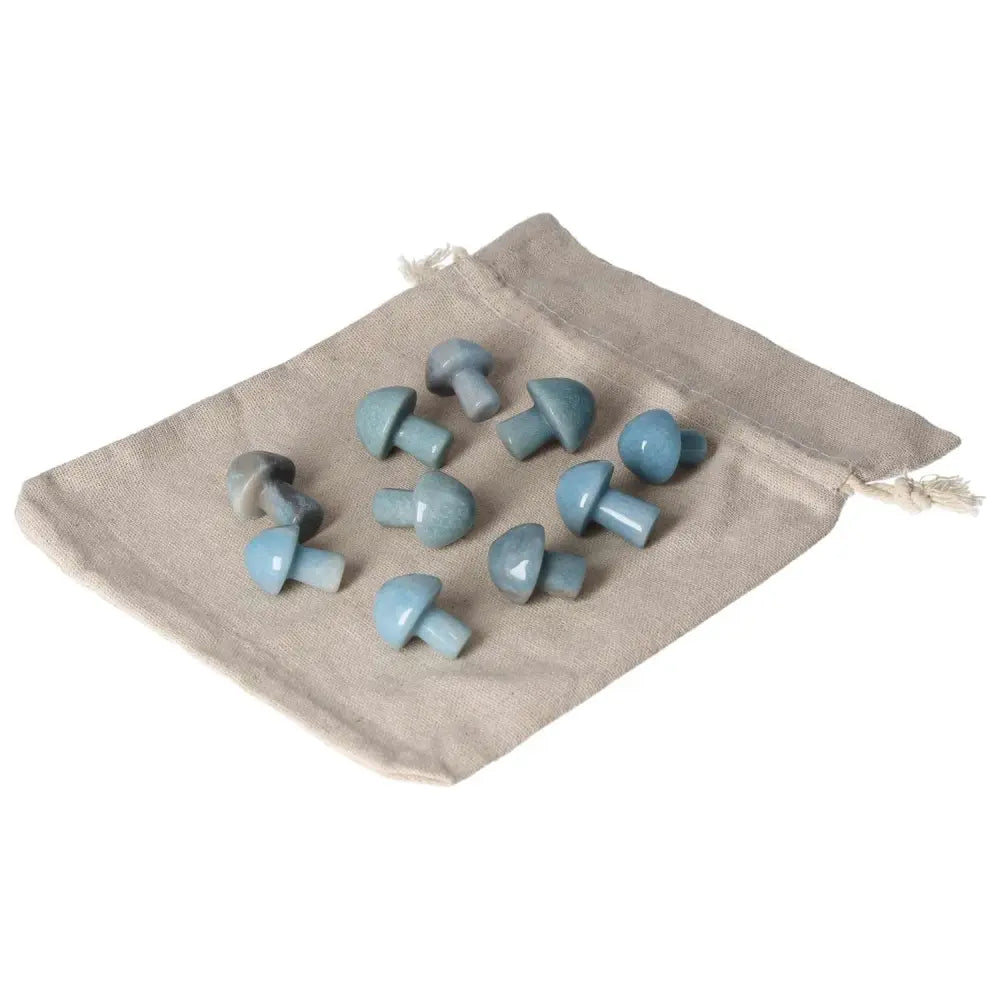 Small blue trolleite mushroom stones on a beige cloth pouch, promoting intuition and spiritual awareness for chakra energy healing.