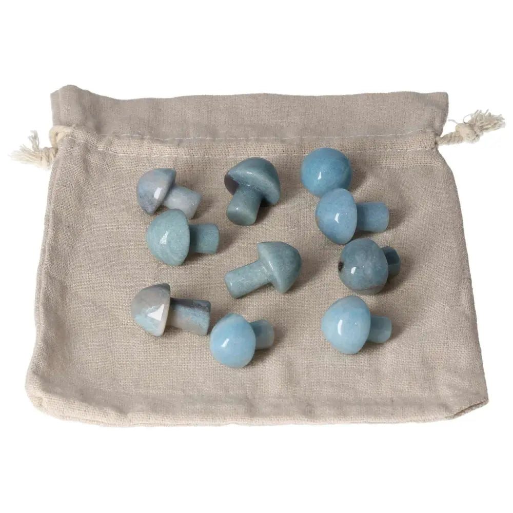 Collection of Trolleite small mushroom stones on a beige pouch, symbolizing intuition, spiritual awareness, and chakra stimulation.