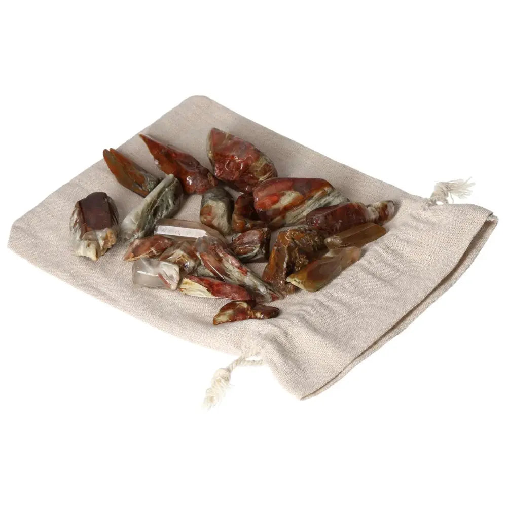 Tumbled Amphibole crystals displayed on a fabric pouch, ideal for enhancing spirituality and luxury in your space.