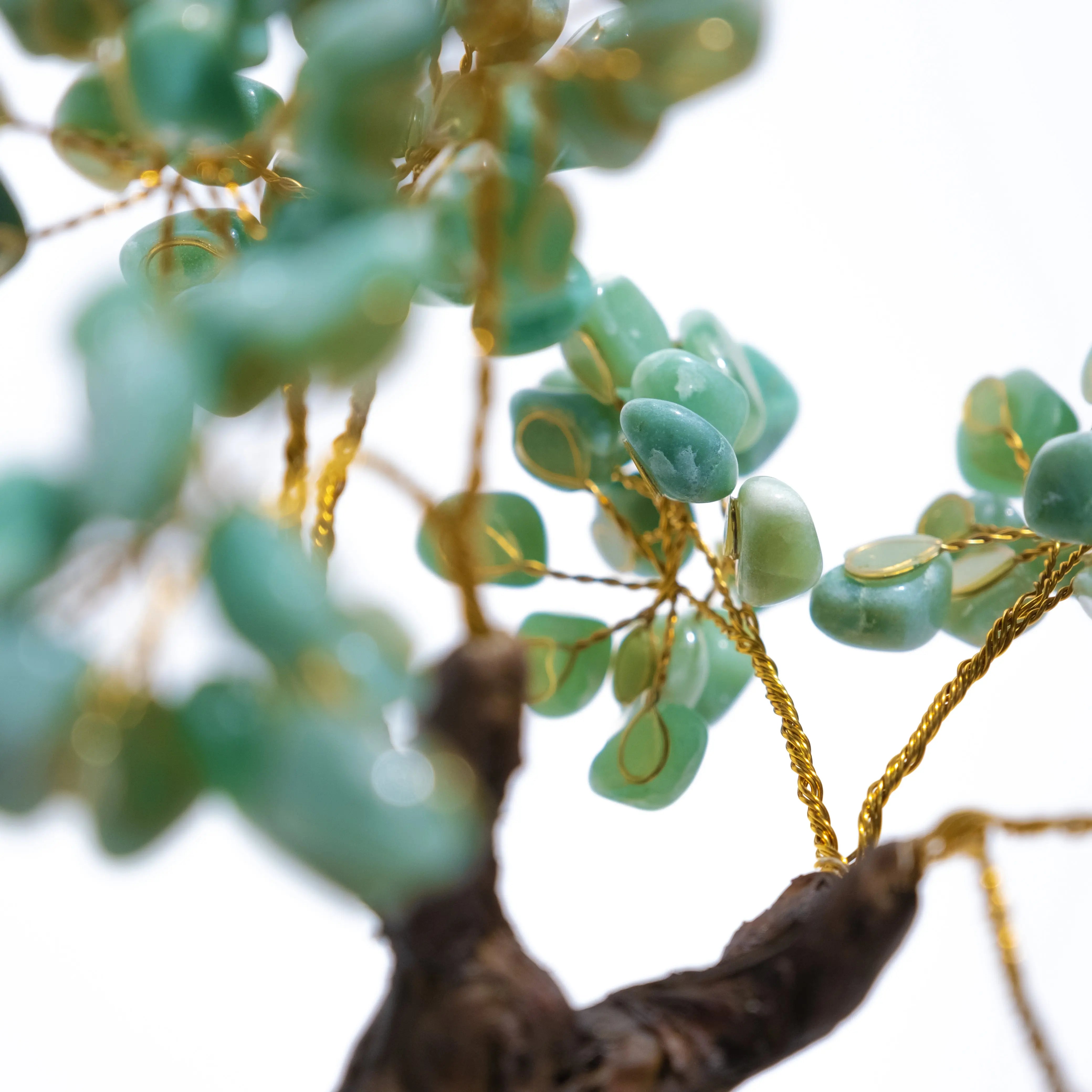 Close-up of a handcrafted Aventurine Crystal Bonsai Tree with green stones and gold wire, symbolizing prosperity and positive energy.