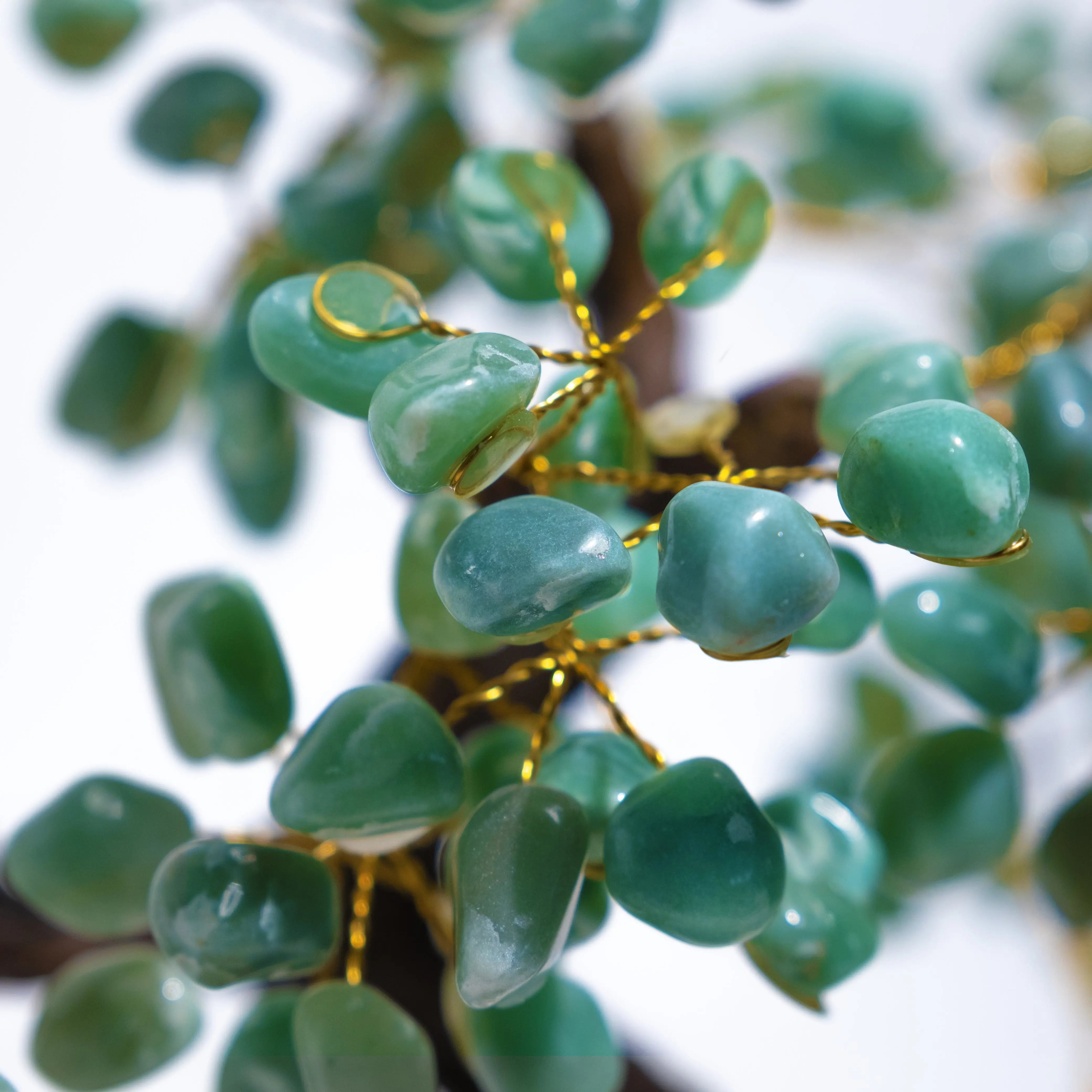 Close-up of tumbled Aventurine leaves on a Bonsai Crystal Tree, symbolizing prosperity and positive energy.