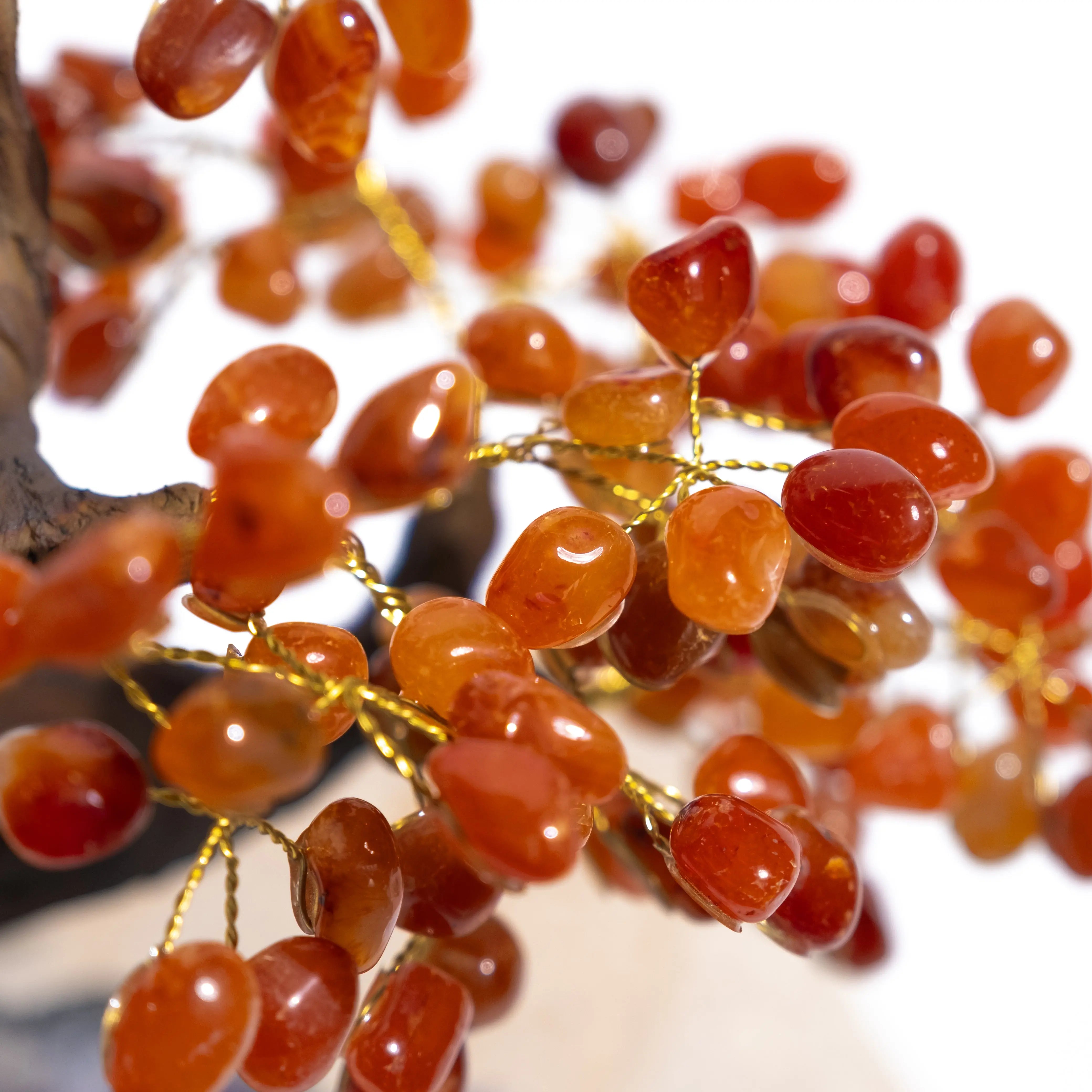 Close-up of a Tumbled Carnelian Bonsai Tree with polished gemstones for creativity and positive energy.