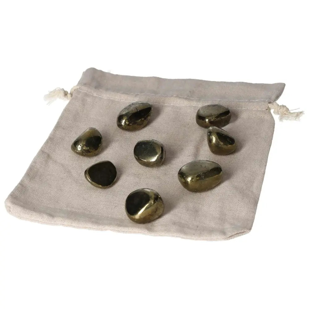 Tumbled Chalcopyrite stones for healing, shown on a beige pouch, promotes positive thinking and enhances psychic abilities.
