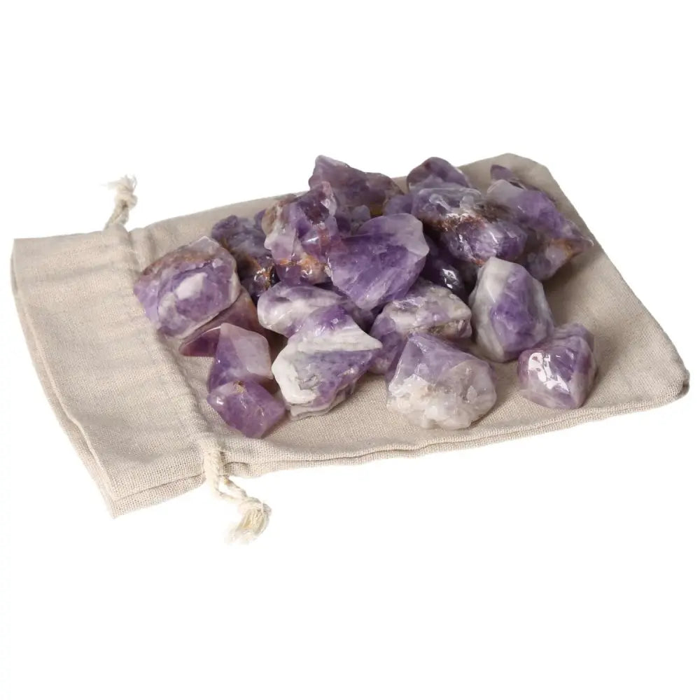 Tumbled Chevron Amethyst stones on linen pouch, showcasing deep purple and white bands, premium crystal collection by Sylvia Crystals.