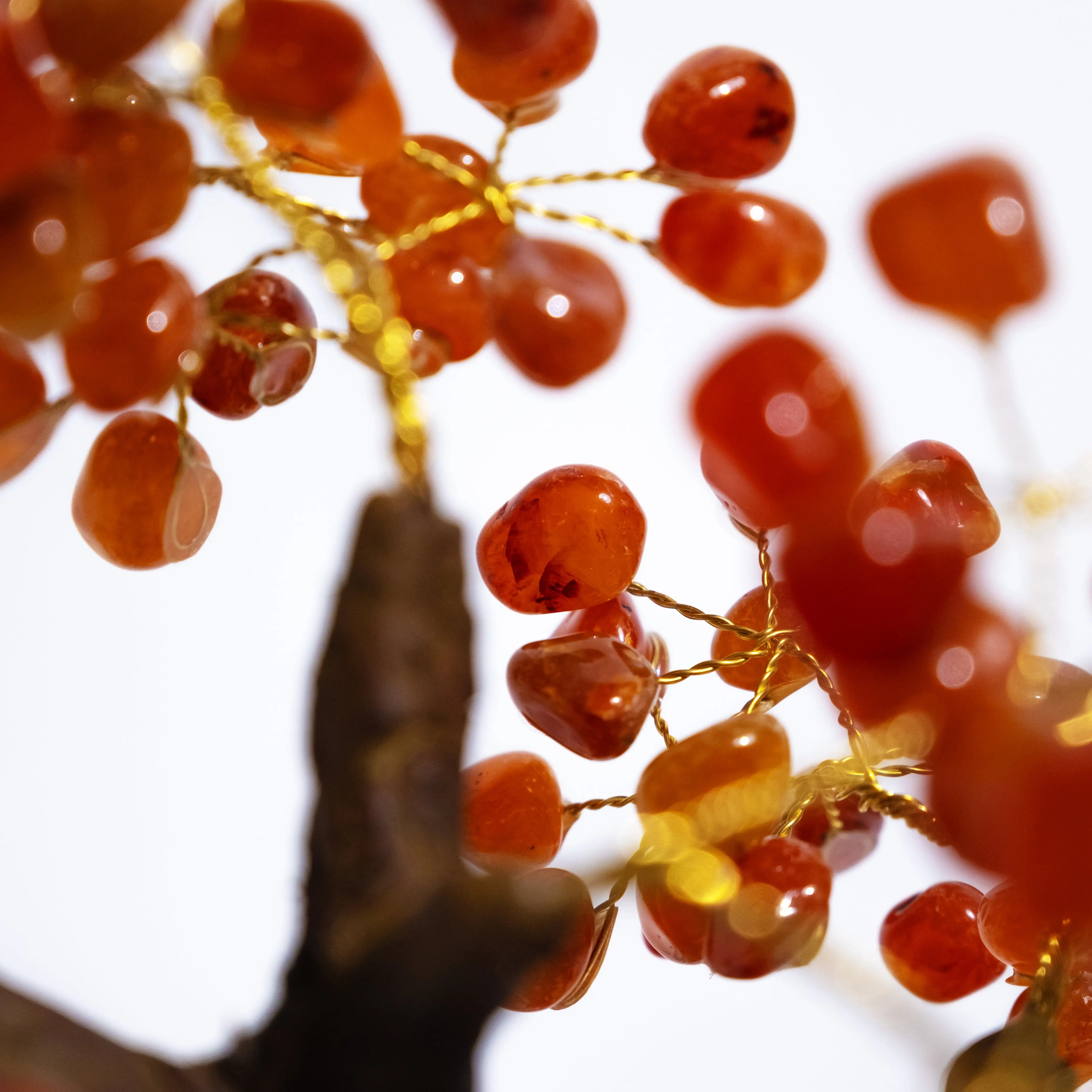 Close-up of handcrafted Tumbled Carnelian Bonsai Tree branch with polished gemstones, promoting creativity and positive energy.