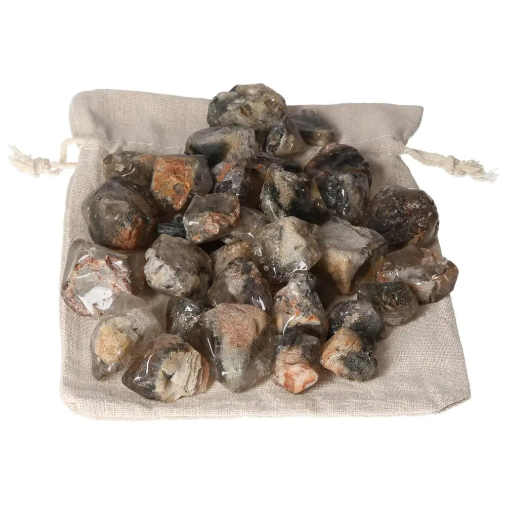 Elegant Tumbled Lodolite gemstones from Sylvia Crystals on a cloth bag, showcasing premium quality and spiritual elegance.
