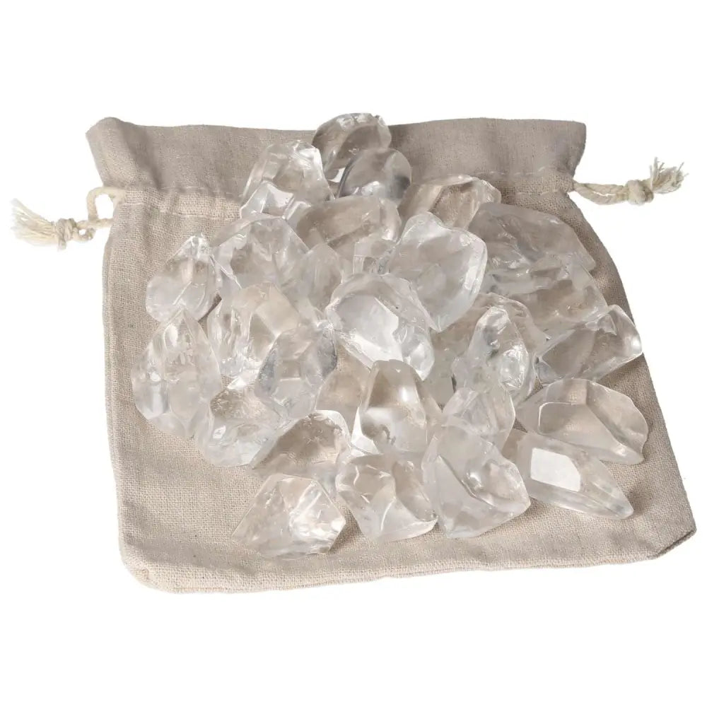 A collection of tumbled quartz ice cubes on a fabric pouch, showcasing their clarity and elegance for spiritual enhancement.