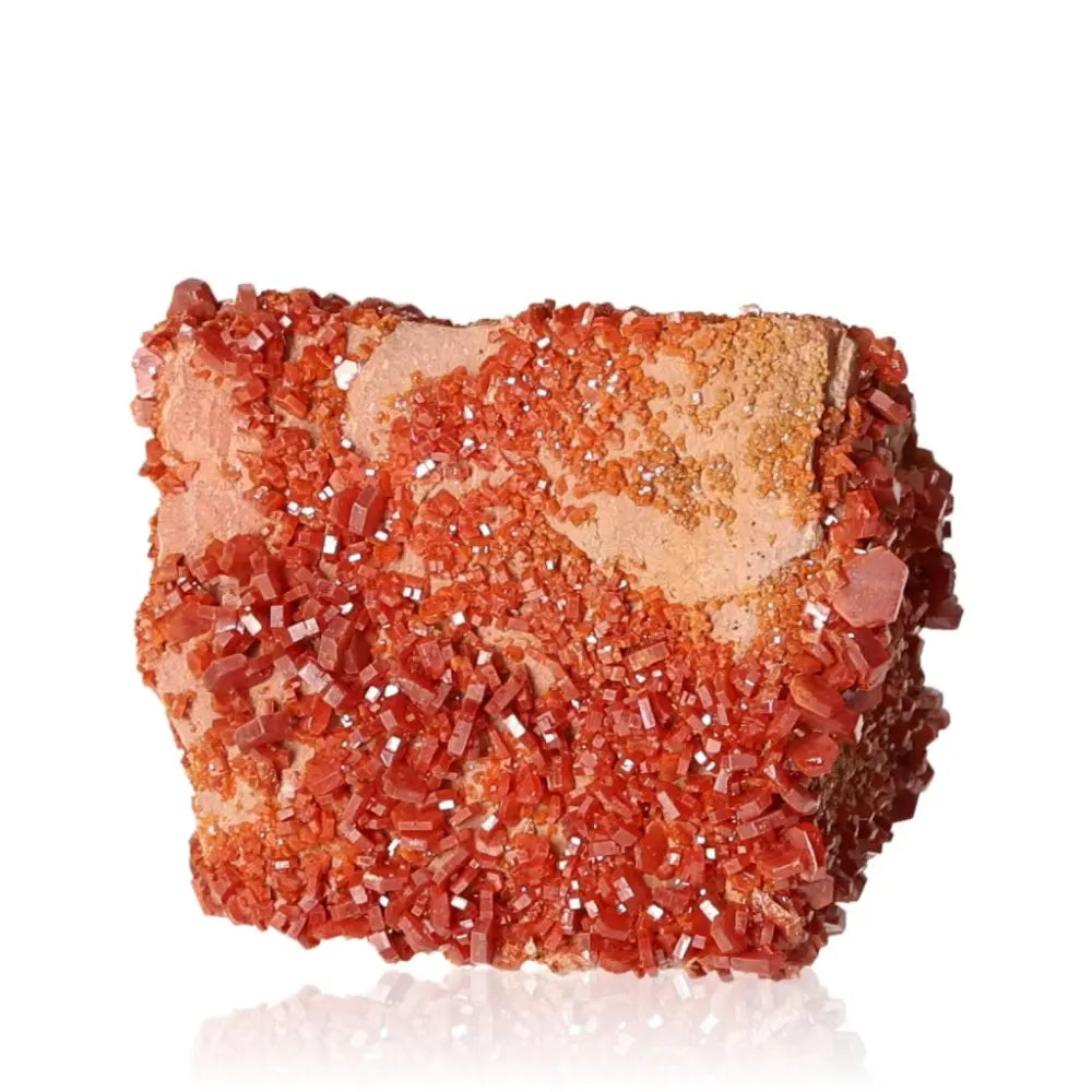 Vibrant red-orange Vanadinite Druze crystal known for enhancing focus and creativity, perfect for collectors and energy seekers.