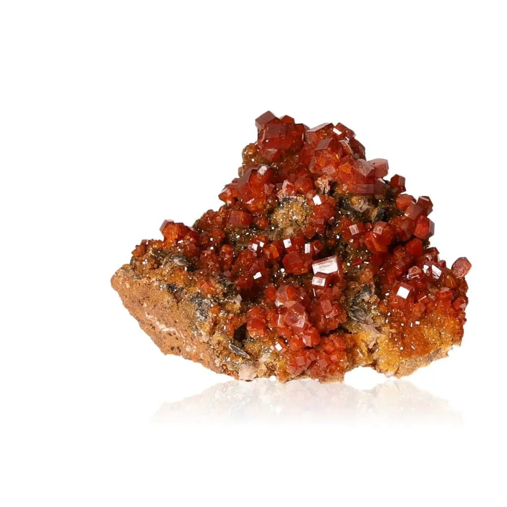 Vibrant red-orange Vanadinite druze, showcasing unique crystal formations, known for focus and creativity-enhancing properties.