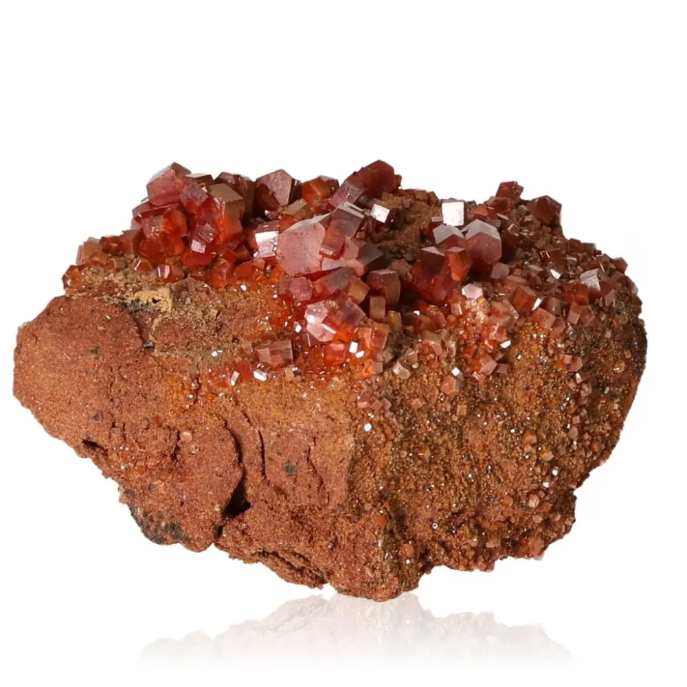 Vanadinite Druze with vibrant red-orange crystals, ideal for creativity and focus seekers, showcased on a natural stone base.