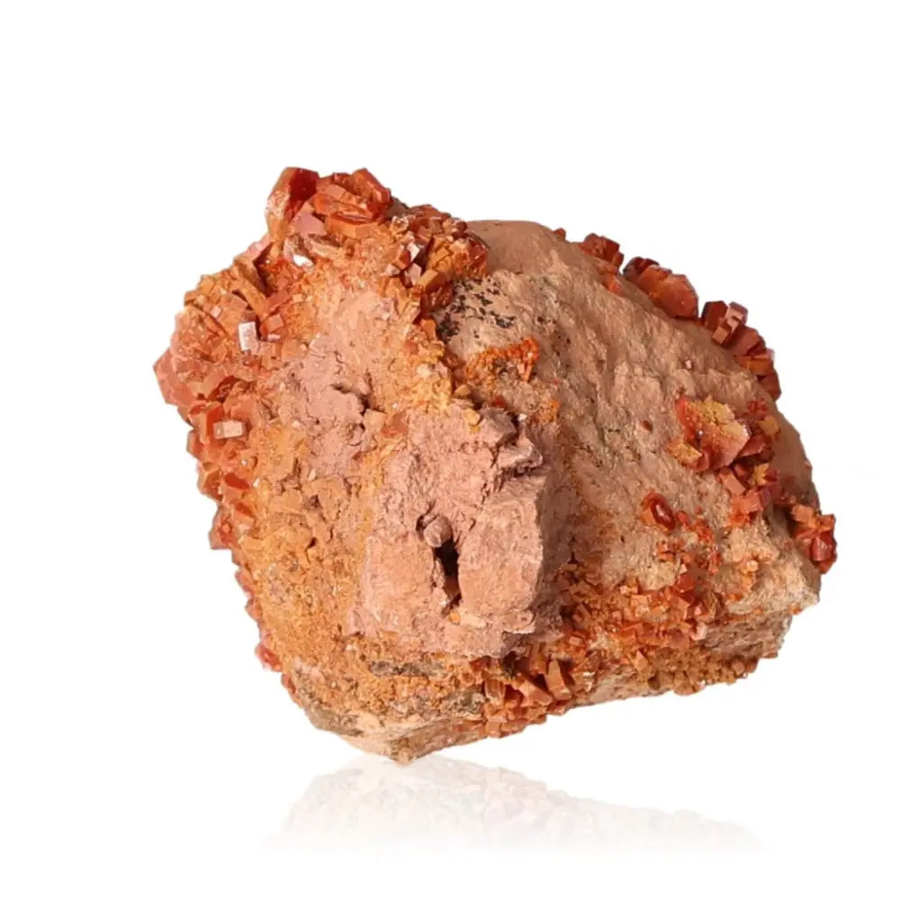 Vanadinite druzy with striking red-orange crystal formations and grounding properties, ideal for collectors and creatives seeking focus.