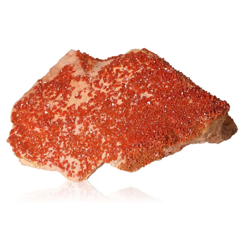 Vibrant red-orange Vanadinite druze crystal showcasing unique formations and grounding properties, ideal for collectors and creatives.