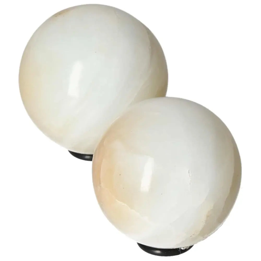 Polished white onyx spheres promoting determination, self-discipline, and emotional healing.