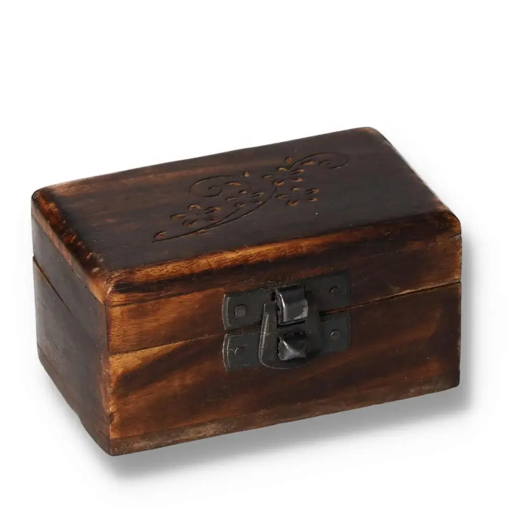 Hand-carved wooden pill box with intricate design, 9x5x4cm, featuring a dark finish and secure metal clasp, ideal for storage.