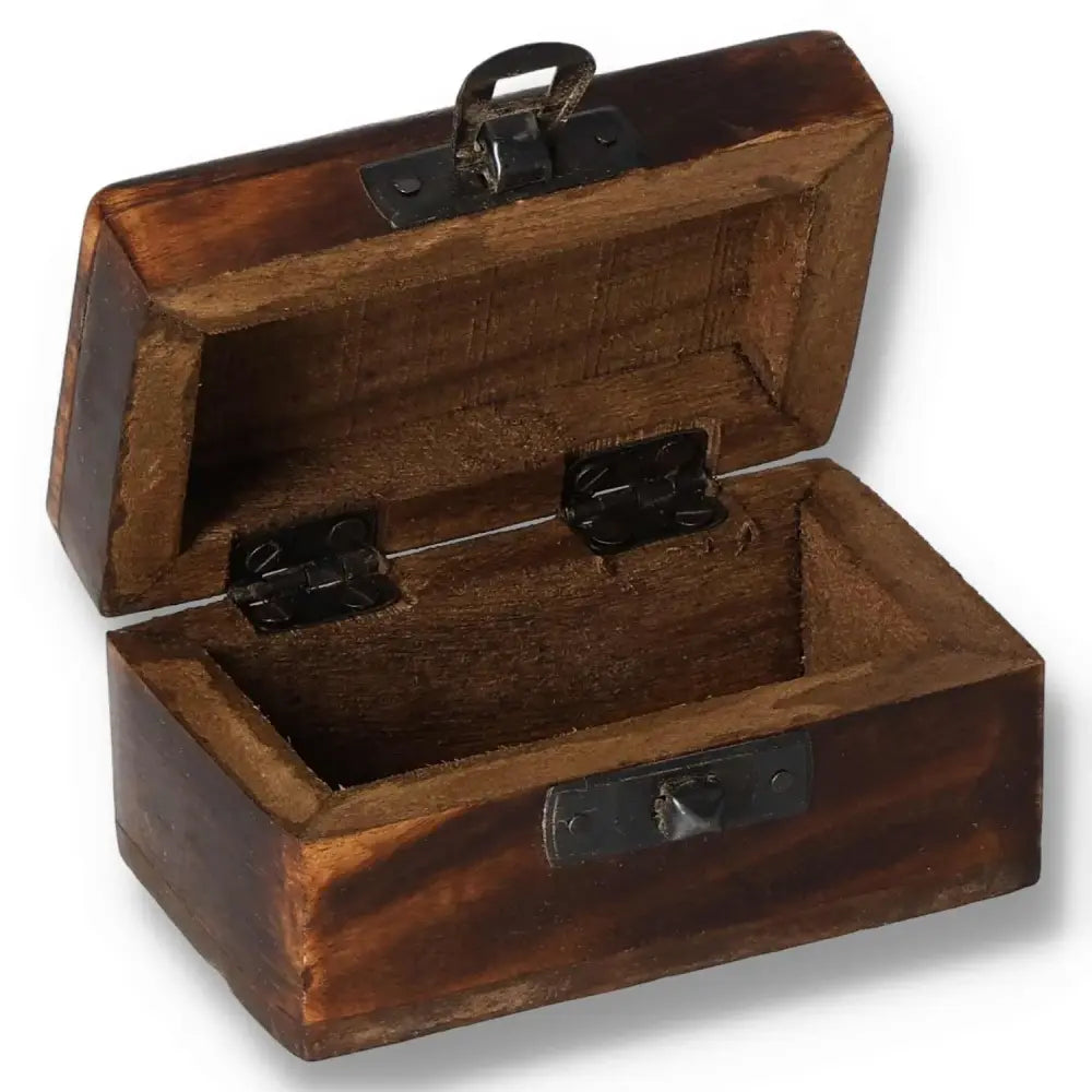 Carved wooden pill box with open lid, measuring 9x5x4 cm. Features a rustic design and sturdy metal hinges. Assorted designs available.