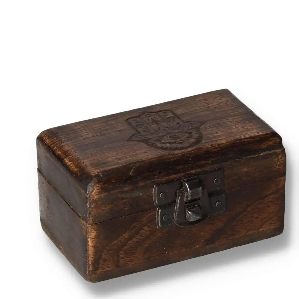 Wooden pill box with carved design, measuring 9x5x4 cm, featuring an intricate latch and crafted from rich brown wood.