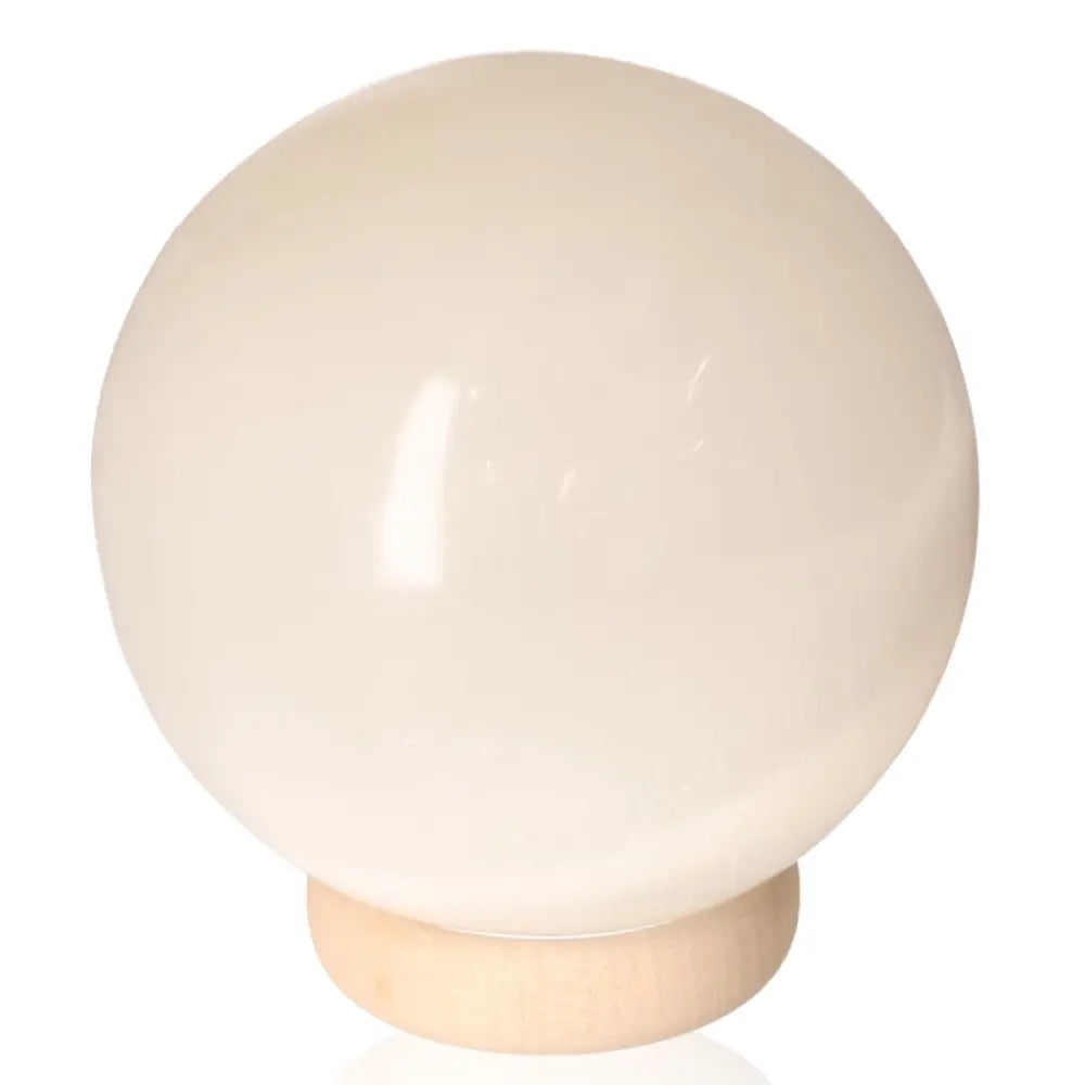 Large 14cm selenite sphere on wooden stand by Sylvia Crystals for spiritual growth and mindful living.