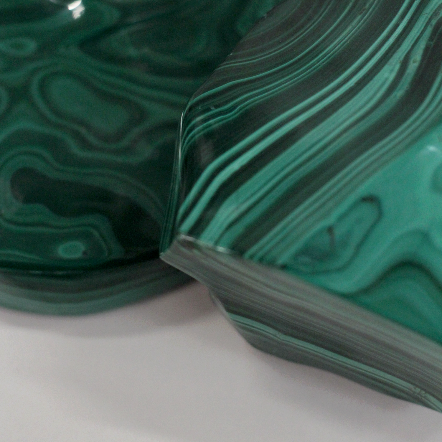 Malachite raw stone with vibrant green bands showcasing its transformative and protective properties, ideal for meditation and healing.