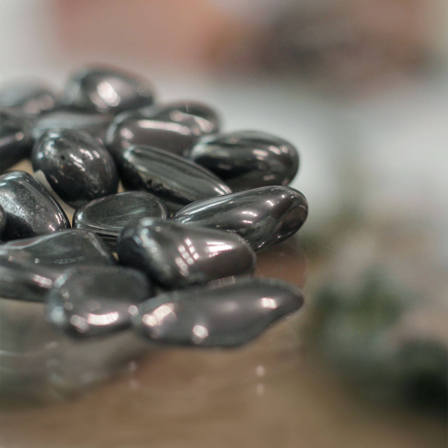 Shiny hematite crystal with sleek metallic sheen, symbolizing strength, grounding, and protection against negativity.