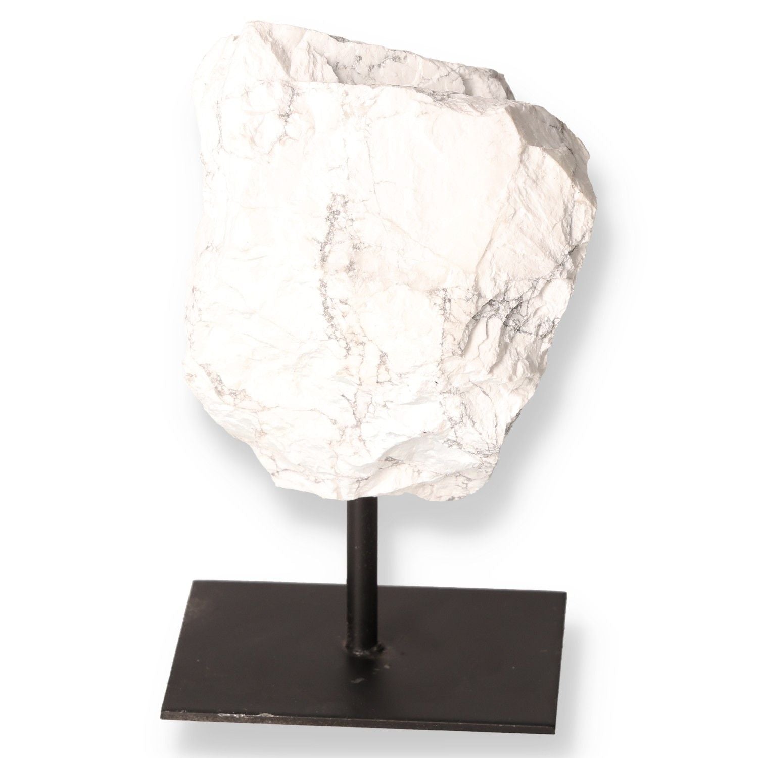 White Howlite gemstone on display stand with natural gray veining, symbolizing calm and awareness.