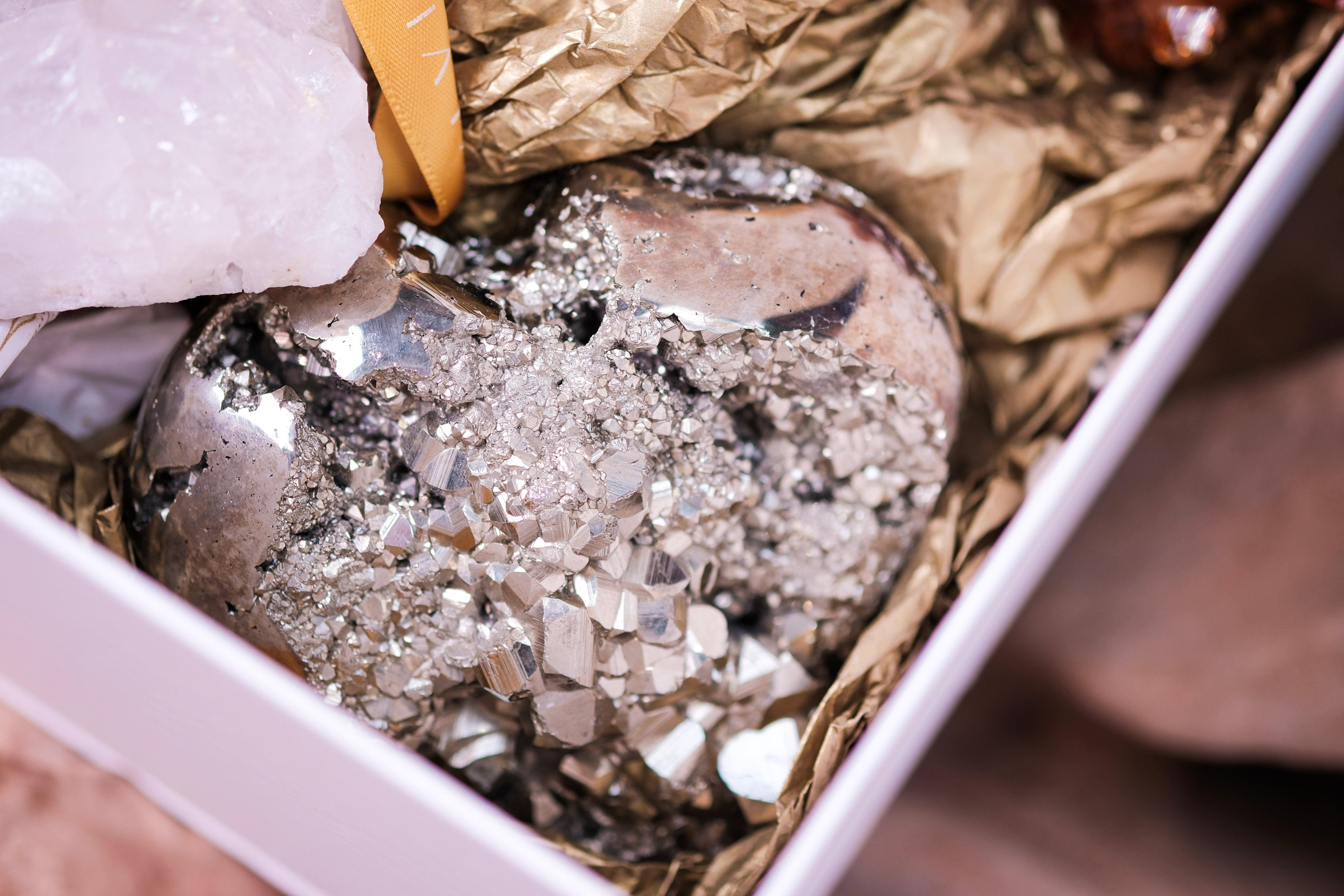 Pyrite heart and white quartz in Wealth and Abundance Deluxe Christmas Box by Sylvia Crystals, perfect for holiday prosperity.